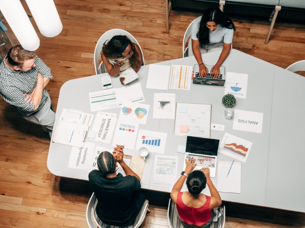 A team collaborates at a work desk